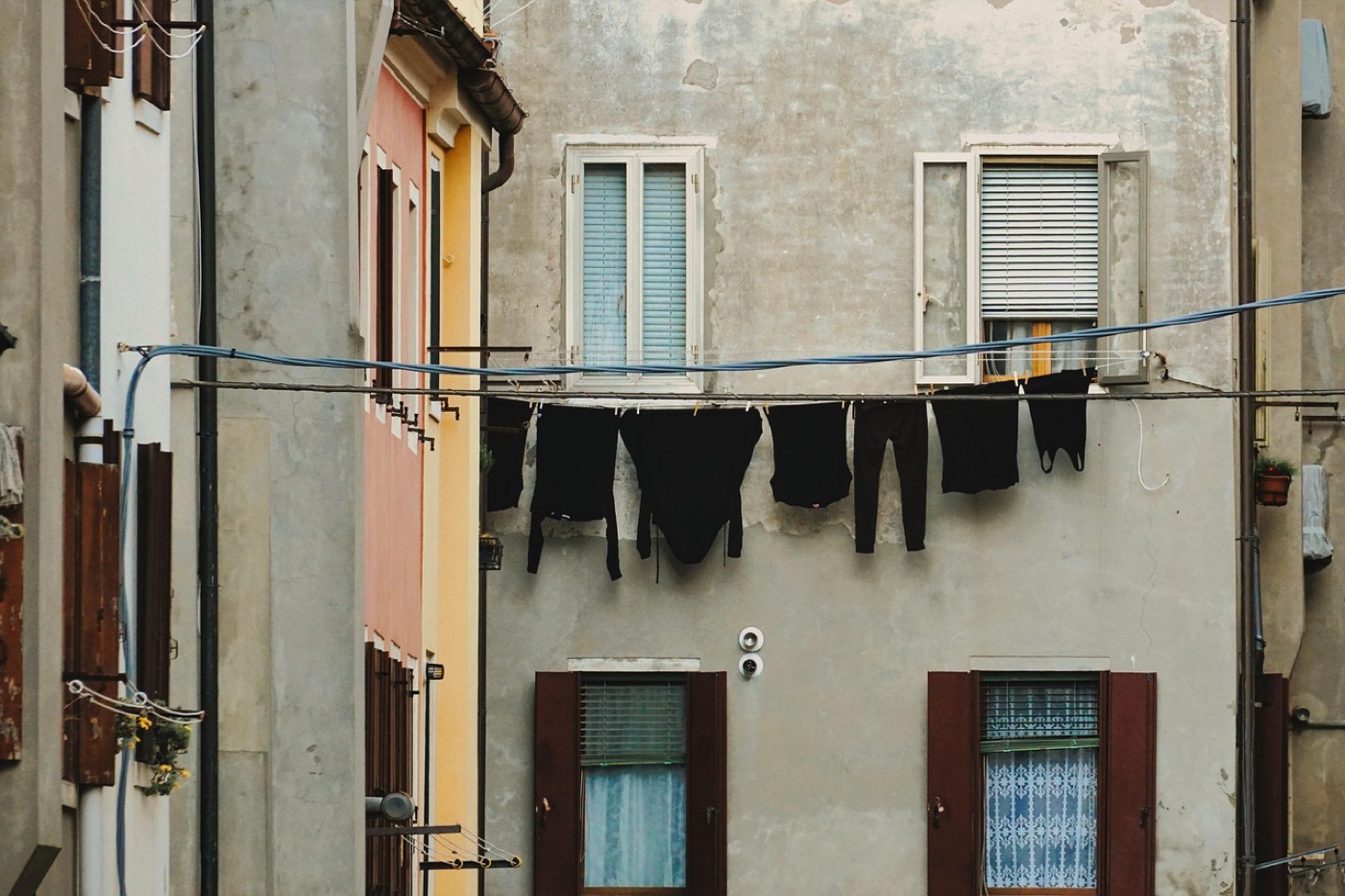 Folded athletic wear drying on a rack near a window