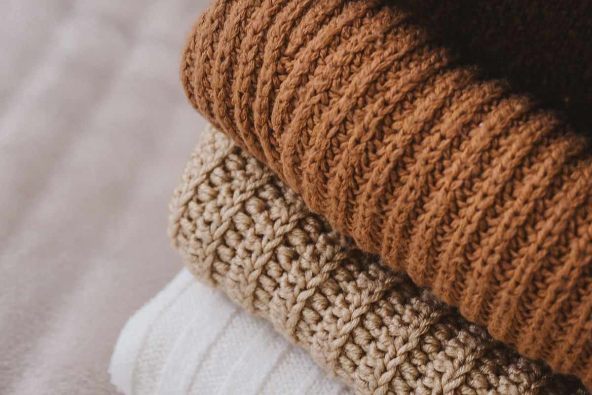 Folded sweaters in warm autumn colours