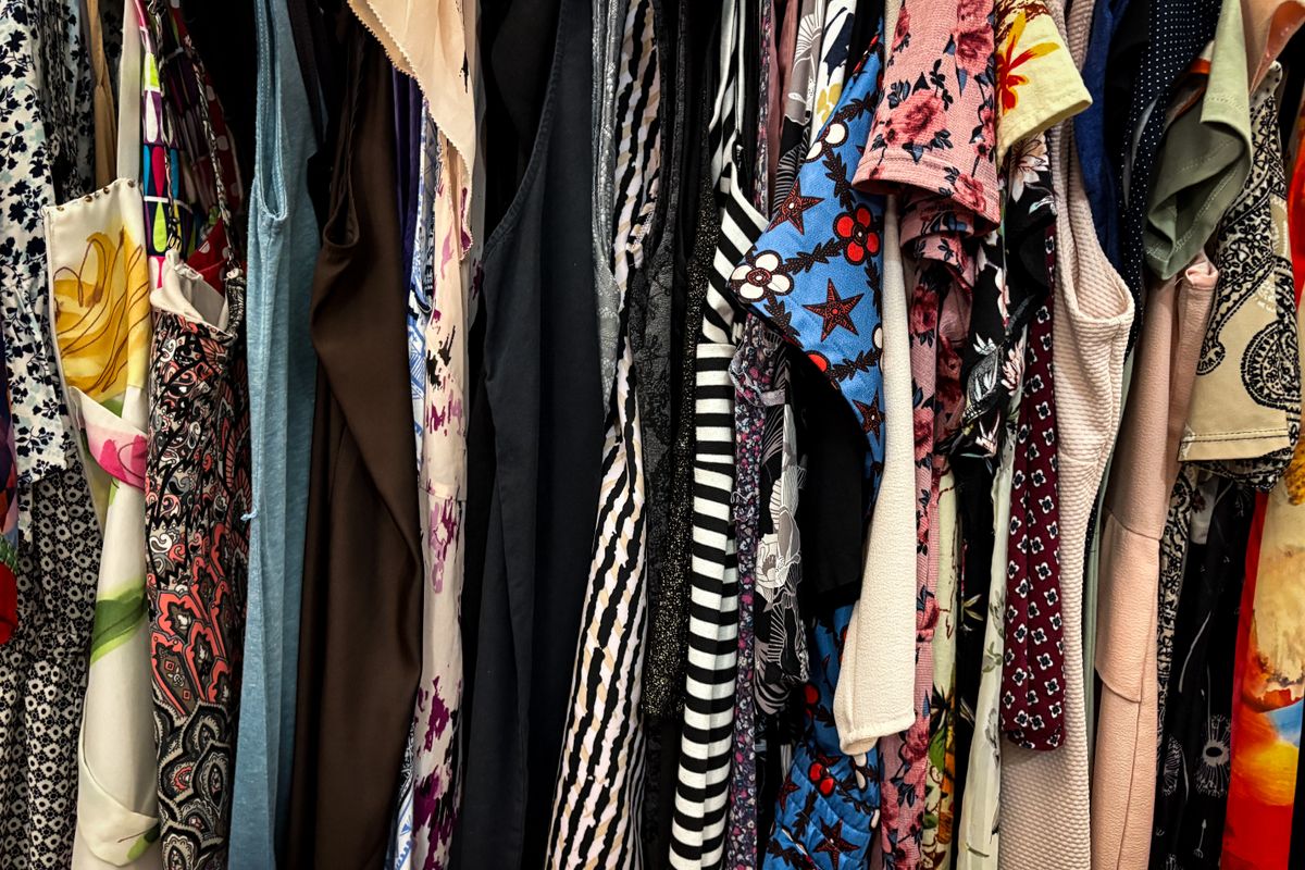 A rack of neatly hung secondhand jackets in a resale shop