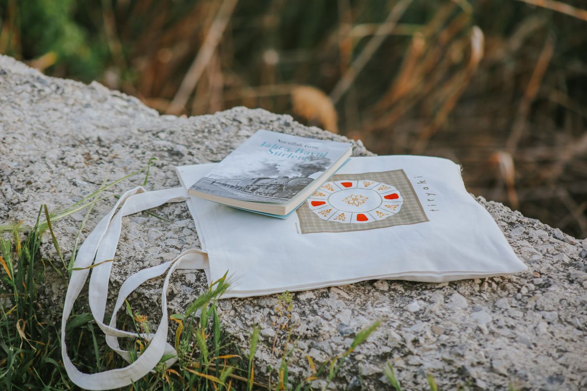 A canvas tote bag resting outdoors