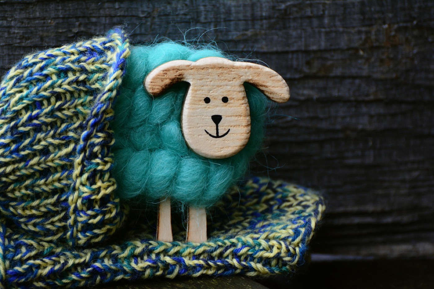 A pair of wool socks folded on a wooden bench