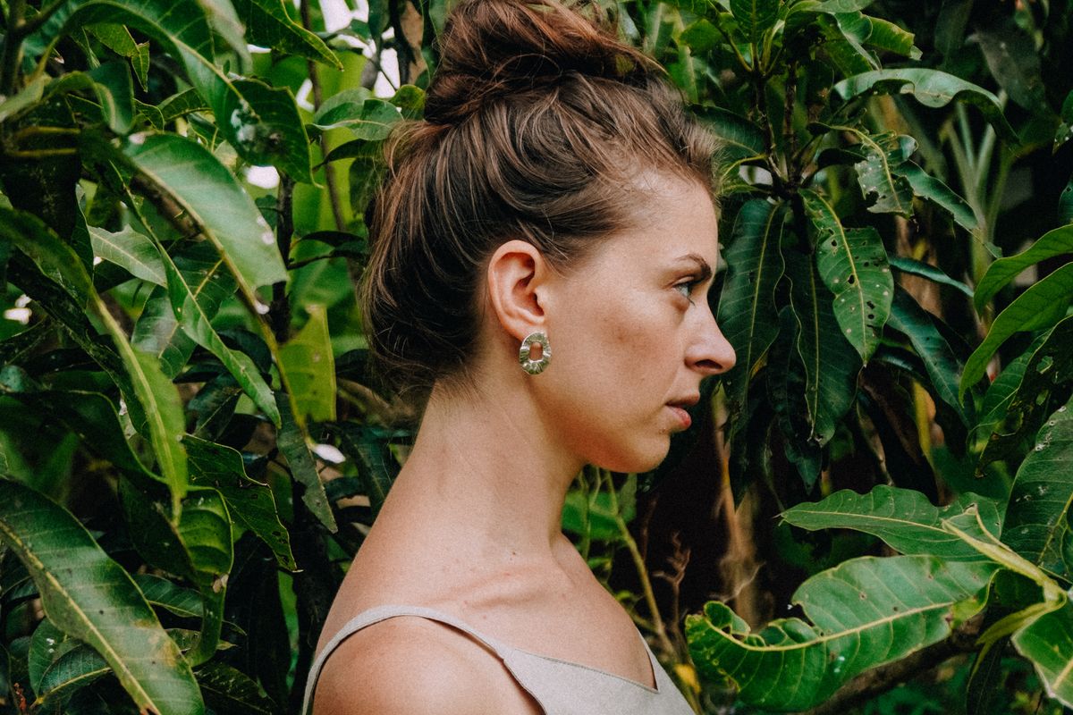 A loose-fitting linen dress photographed among plants